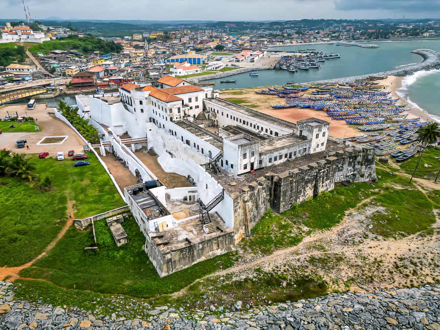 From Accra: Cape Coast, Elmina Castle & Kakum Park Day Tour - Elmina Castle and the first European-built structure