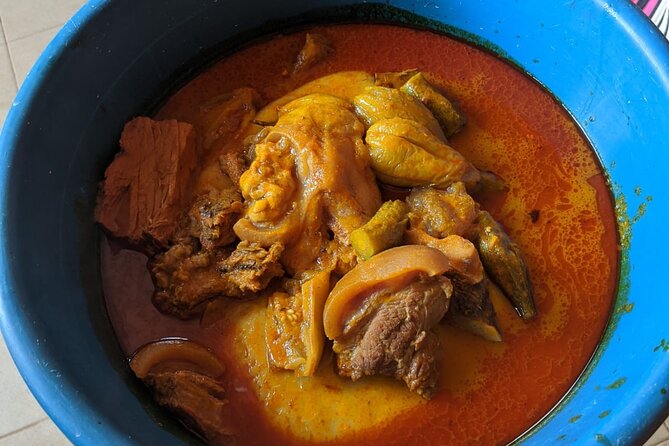 Local Ghanaian Cooking Class in Accra to help support wellness community center - Sitting down to eat the food you made